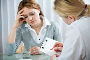 Psychiatrist nurse talking to female patient